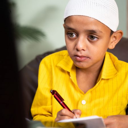 Muslim,Kid,Writing,Notes,During,Online,Class,In,Video,Call